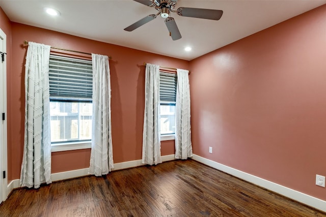 unfurnished room featuring ceiling fan and dark hardwood / wood-style flooring