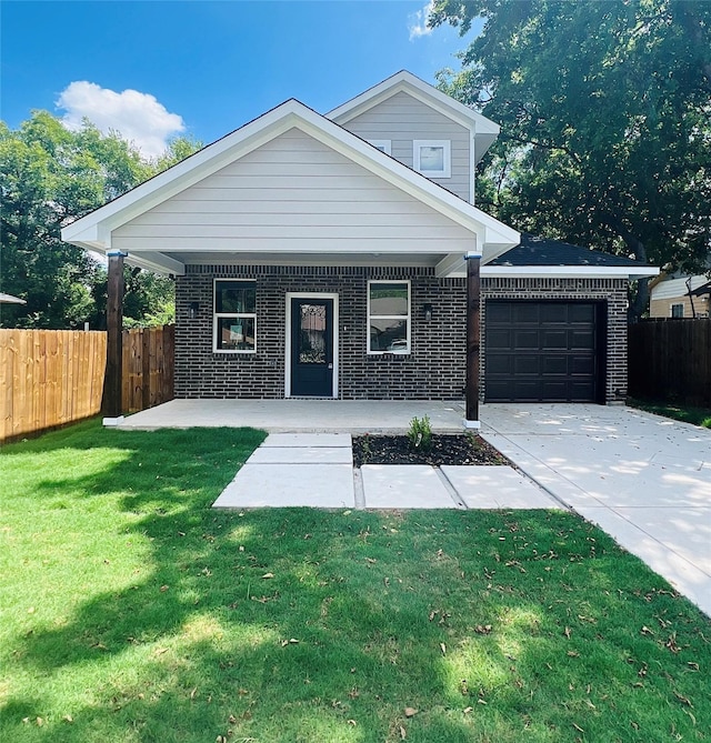 view of front of property featuring a front yard, a porch, and a garage