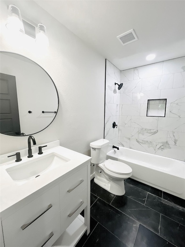 full bathroom featuring vanity, toilet, and tiled shower / bath