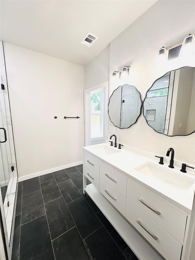 bathroom with vanity and a shower with shower door