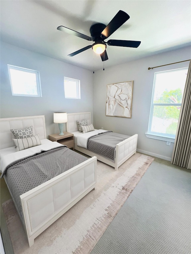 bedroom featuring ceiling fan and light carpet