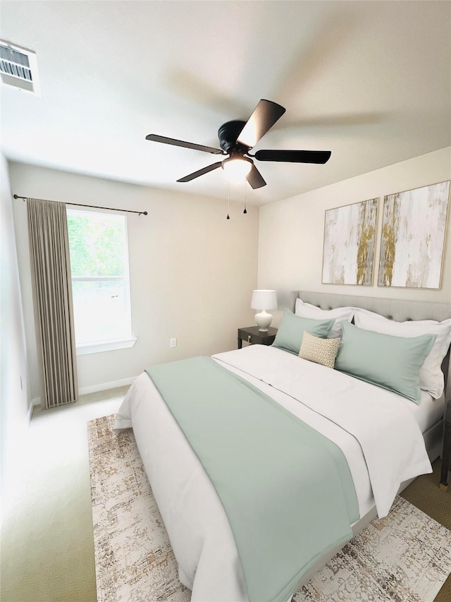 bedroom featuring ceiling fan and light carpet