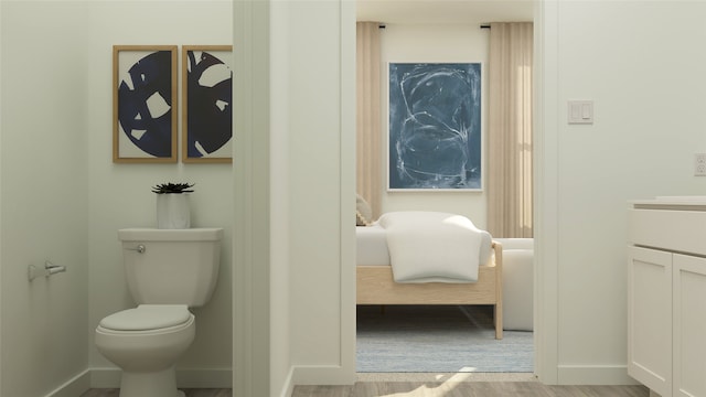 bathroom with hardwood / wood-style floors, vanity, and toilet