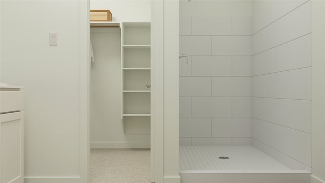 bathroom featuring a shower and vanity