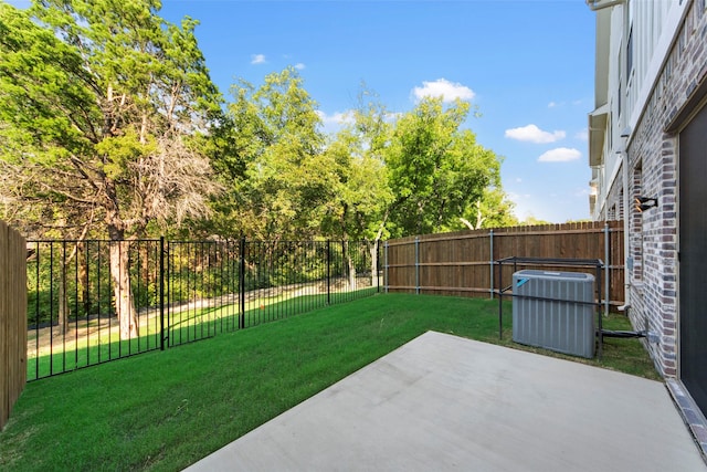 view of yard featuring a patio and central AC