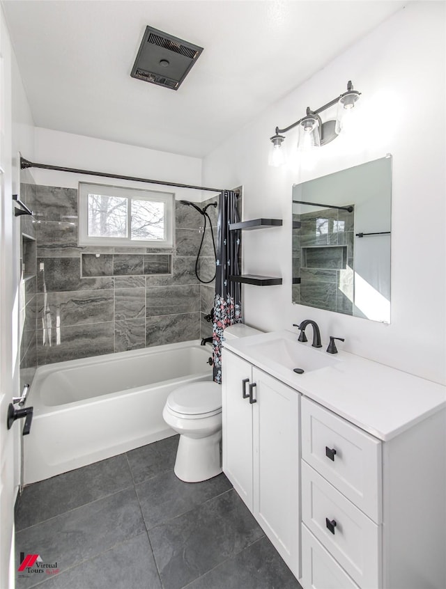 full bathroom with tile patterned flooring, toilet, vanity, and tiled shower / bath