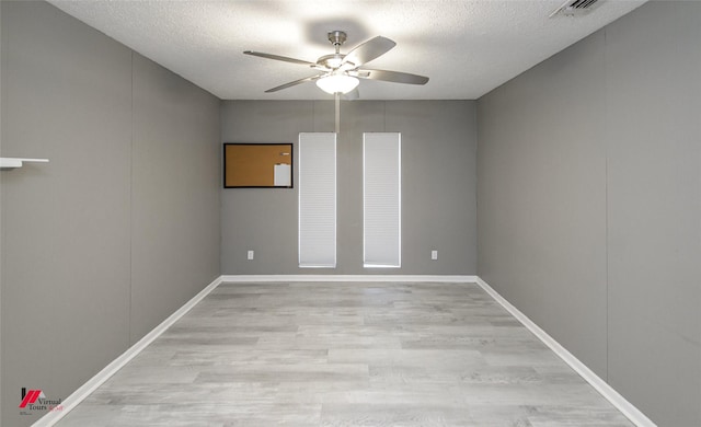 unfurnished room with ceiling fan, light hardwood / wood-style floors, and a textured ceiling