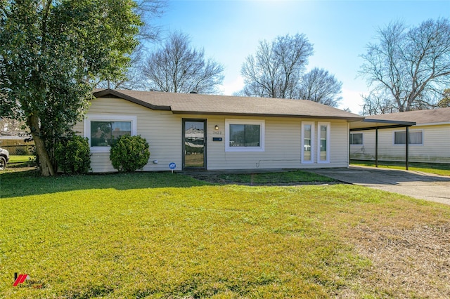 ranch-style house featuring a carport and a front lawn