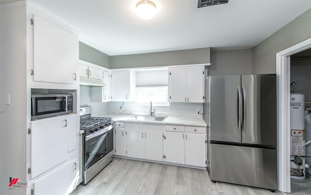 kitchen with white cabinetry, sink, and stainless steel appliances