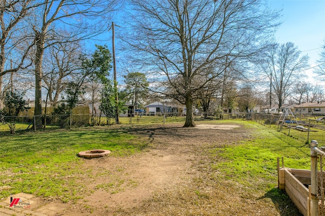 view of yard with a fire pit