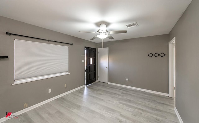 empty room featuring light hardwood / wood-style flooring and ceiling fan