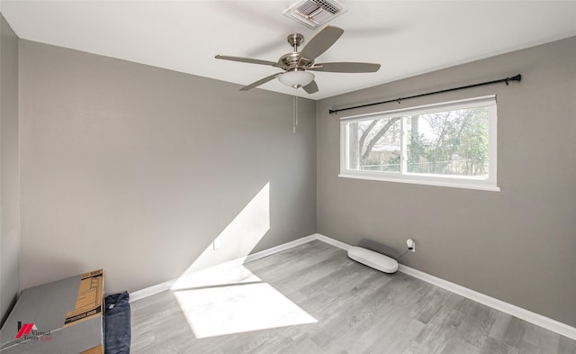 empty room featuring ceiling fan and light hardwood / wood-style floors