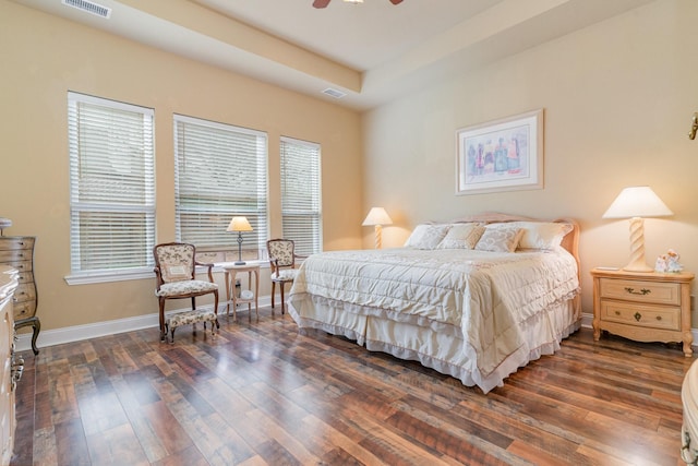 bedroom featuring a tray ceiling and dark hardwood / wood-style floors