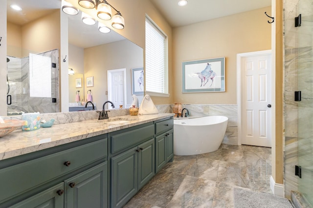 bathroom featuring vanity, separate shower and tub, and tile walls