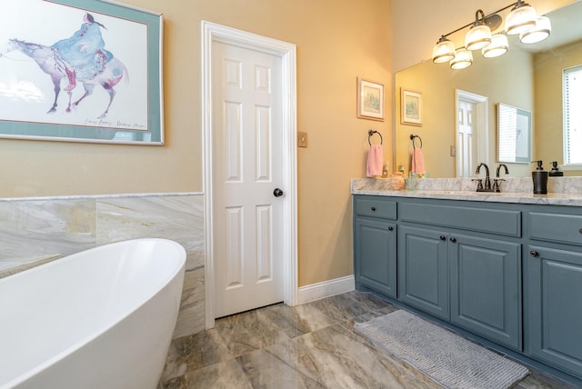 bathroom with vanity, a washtub, and an inviting chandelier