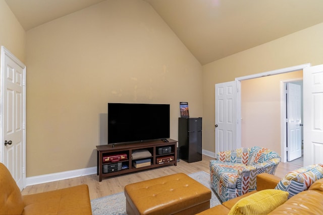 living room featuring lofted ceiling and hardwood / wood-style floors