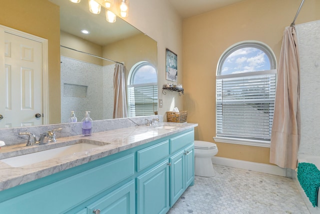 bathroom featuring vanity, toilet, and a shower with shower curtain