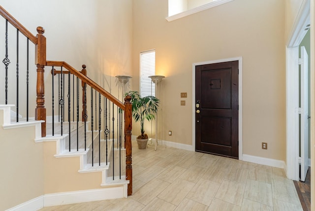 entryway featuring a towering ceiling