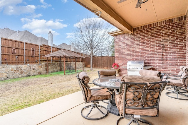 view of patio / terrace with area for grilling and ceiling fan