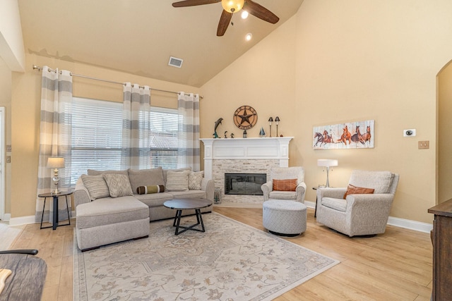 living room with ceiling fan, high vaulted ceiling, and hardwood / wood-style floors