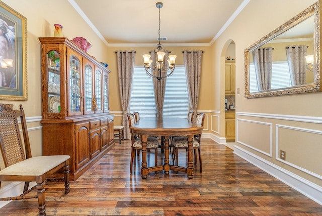 dining area with dark hardwood / wood-style flooring, a notable chandelier, and crown molding