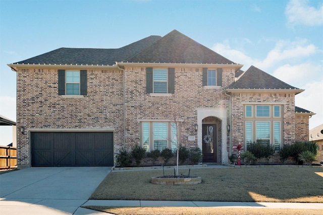 view of front of property featuring a front yard and a garage