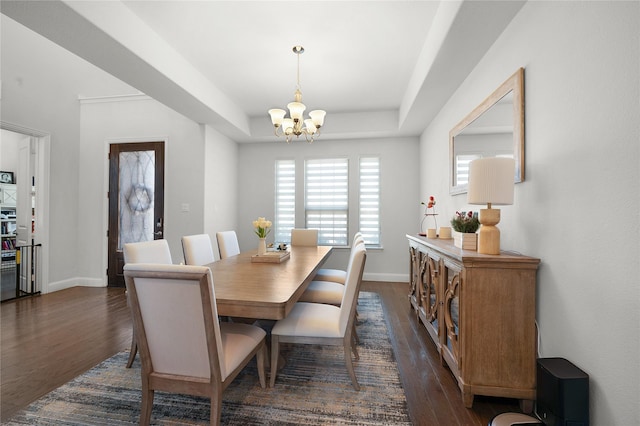 dining space featuring a notable chandelier, baseboards, a raised ceiling, and dark wood-style flooring