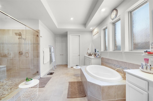 bathroom featuring vanity, a shower stall, a bath, tile patterned floors, and a raised ceiling