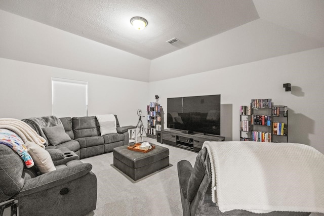 carpeted living area with visible vents and a textured ceiling