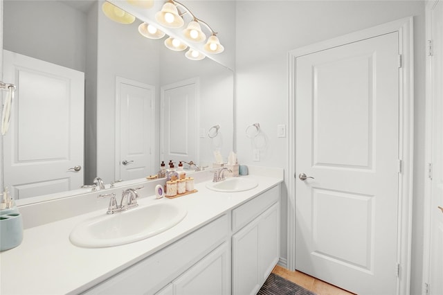 bathroom with tile patterned flooring, a sink, and double vanity