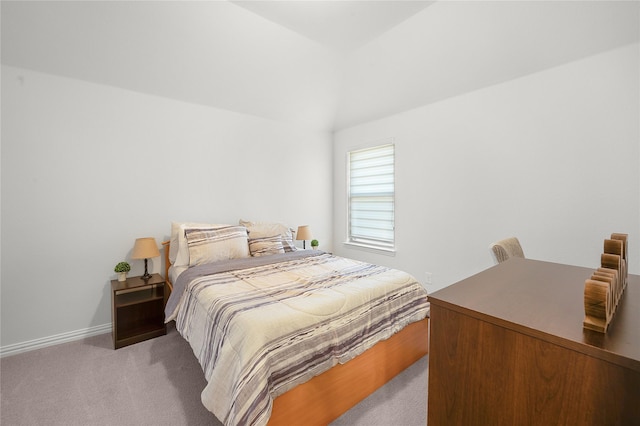 bedroom featuring vaulted ceiling, carpet flooring, and baseboards