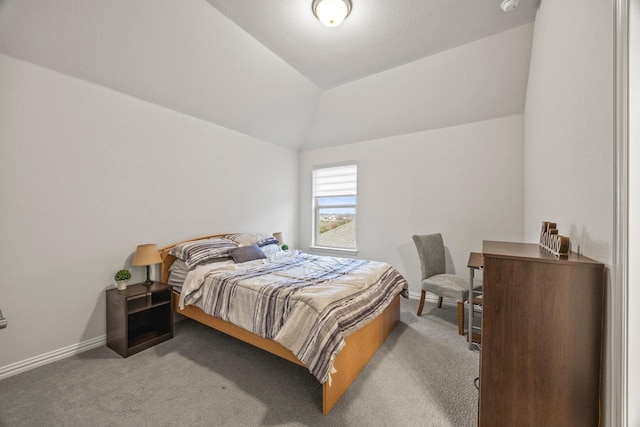 carpeted bedroom with lofted ceiling and baseboards