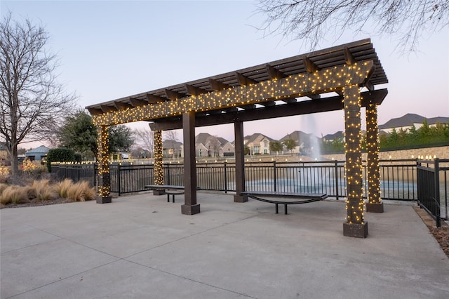 view of home's community with fence and a pergola