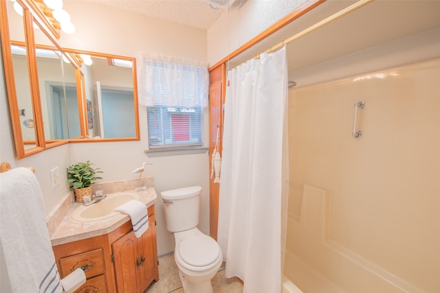 bathroom featuring tile patterned flooring, vanity, toilet, and a textured ceiling