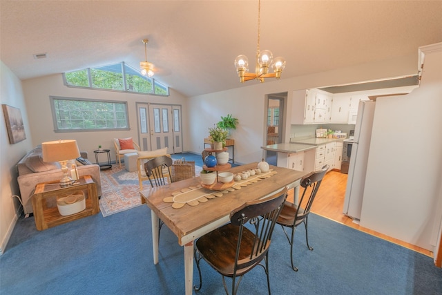 dining area featuring a chandelier and vaulted ceiling