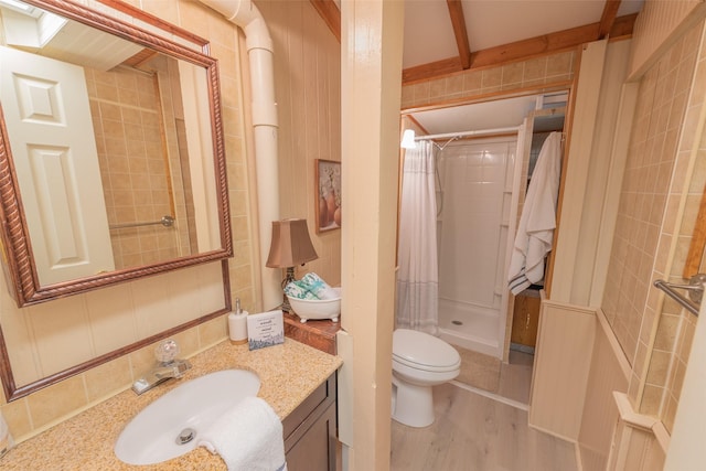 bathroom with hardwood / wood-style flooring, vanity, toilet, and walk in shower