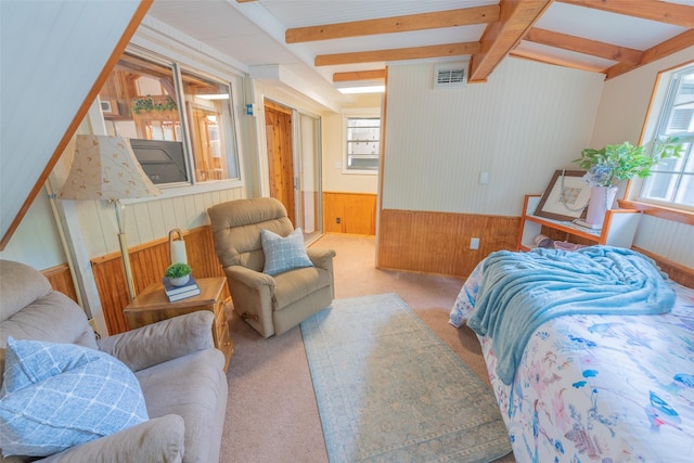 carpeted bedroom featuring beamed ceiling