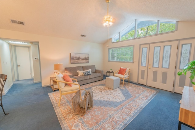 carpeted living room with high vaulted ceiling