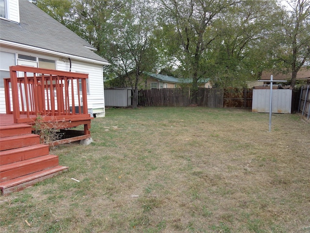 view of yard with a wooden deck and a shed