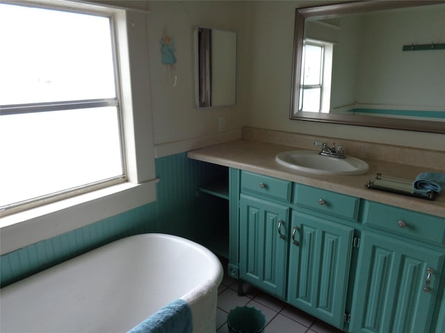 bathroom with tile patterned floors, vanity, and a bath