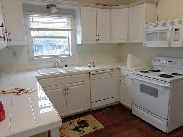 kitchen featuring white cabinets, tile counters, white appliances, and sink