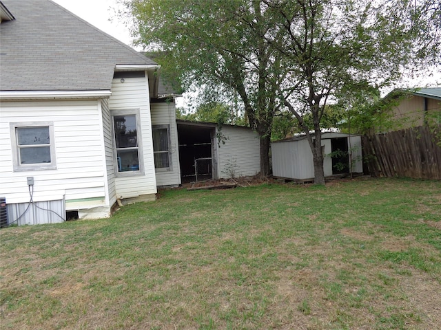 view of yard with central AC and a storage shed