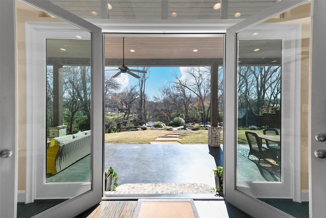 doorway to outside featuring ceiling fan