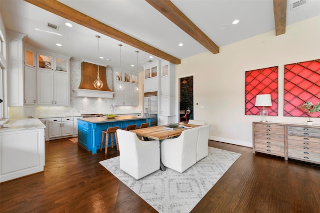 kitchen featuring a center island, custom range hood, blue cabinetry, white cabinets, and beamed ceiling