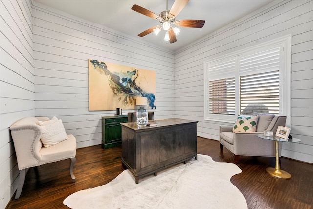 office featuring wood walls, ceiling fan, and dark wood-type flooring