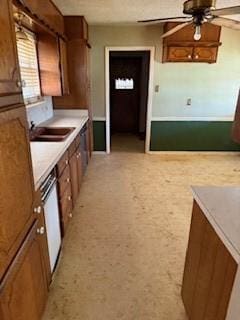 kitchen featuring white dishwasher, ceiling fan, and sink