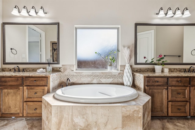 bathroom featuring a garden tub and vanity