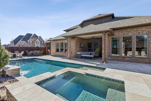 view of pool featuring a patio area, an in ground hot tub, outdoor lounge area, and fence