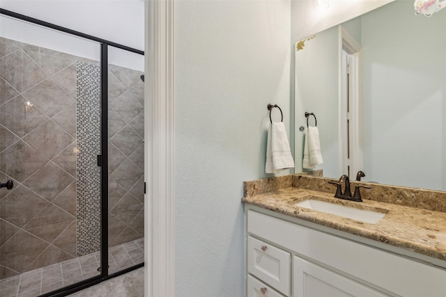 full bath featuring vanity and a shower stall