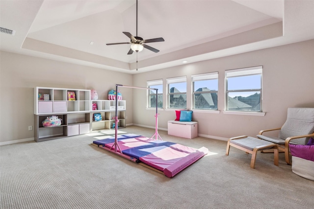 playroom with a raised ceiling, carpet, and visible vents